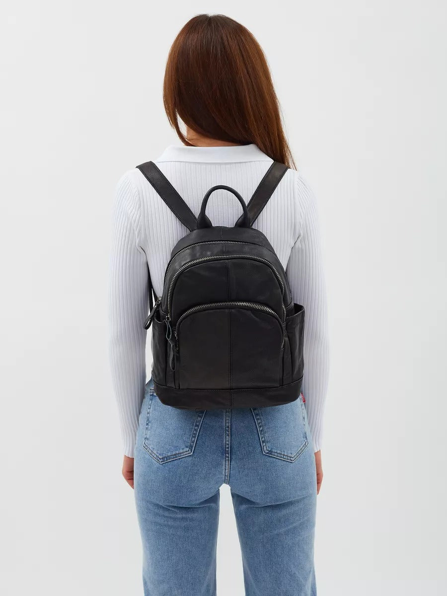 Black leather backpack for women, compact size, zippered pockets, adjustable straps, urban design, Mana model