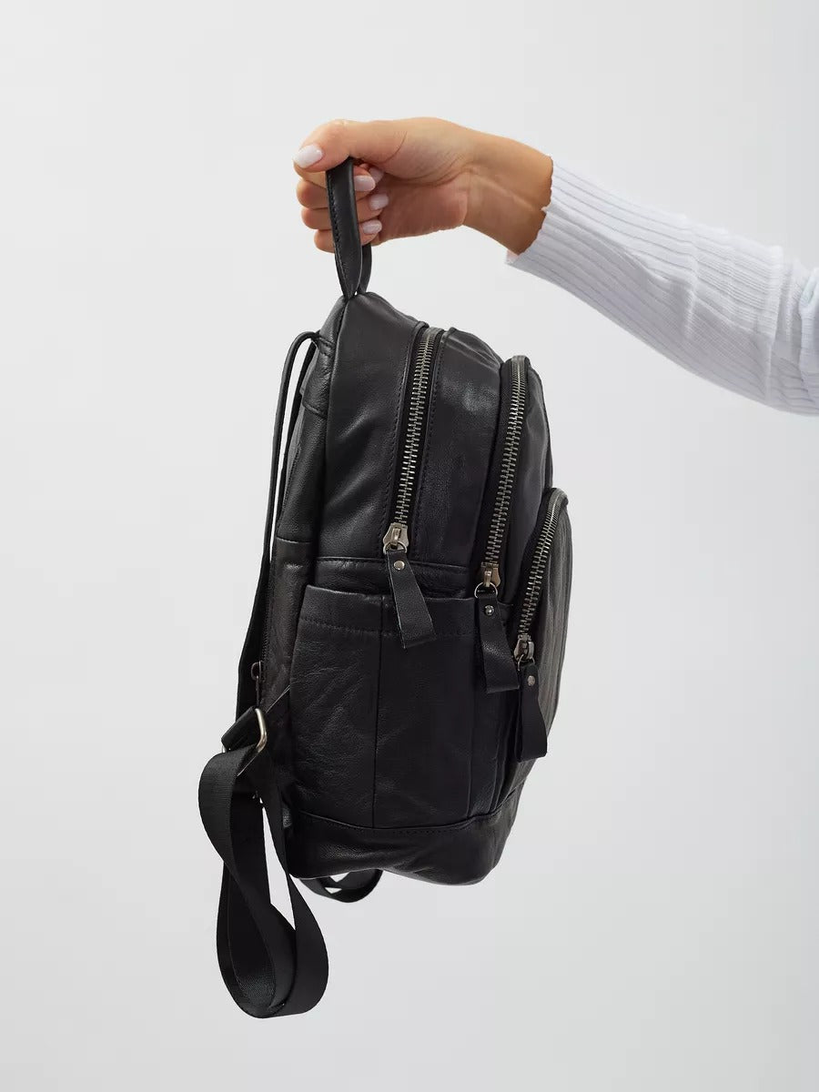 Black leather backpack for women, compact size, zippered pockets, adjustable straps, urban design, Mana model
