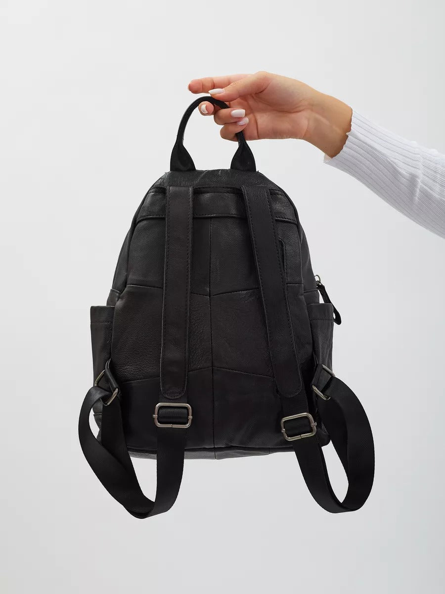 Black leather backpack for women, compact size, zippered pockets, adjustable straps, urban design, Mana model
