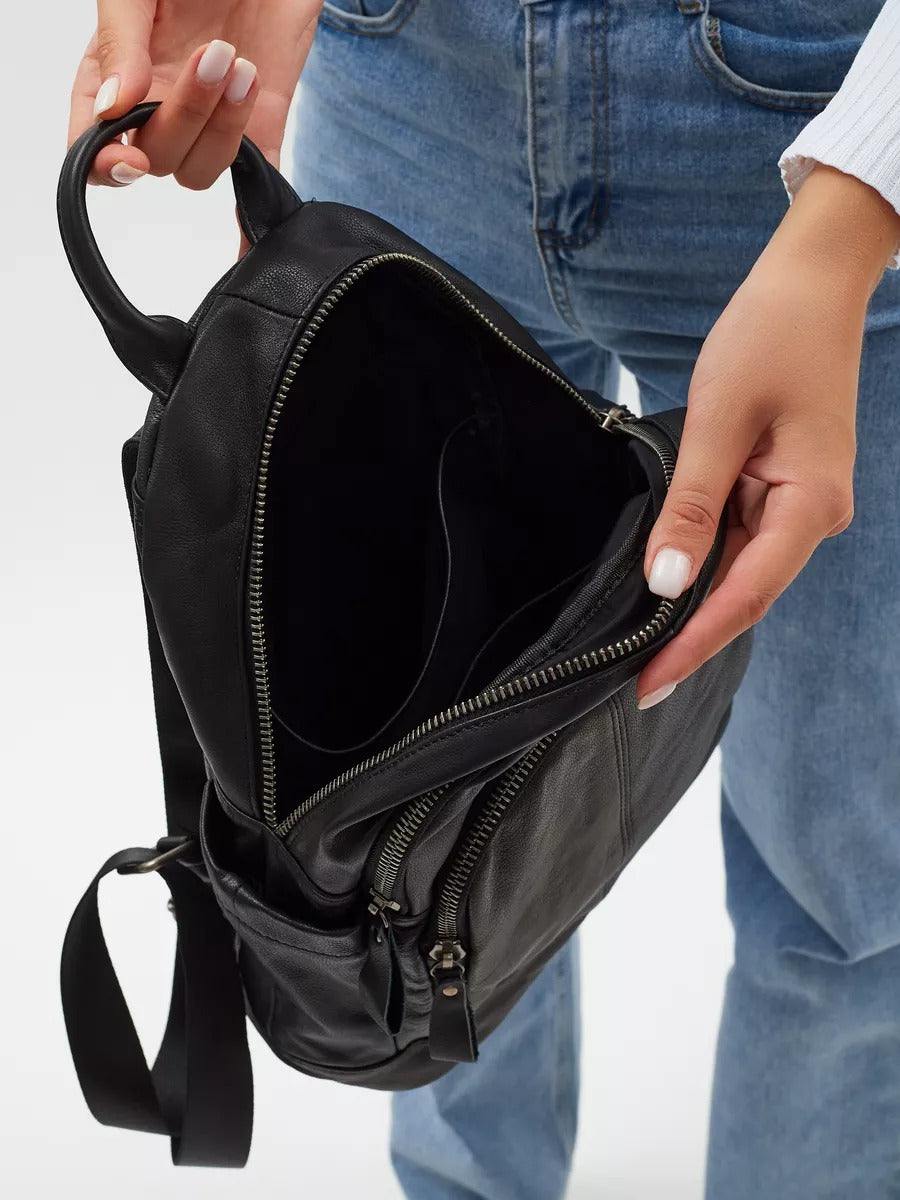 Black leather backpack for women, compact size, zippered pockets, adjustable straps, urban design, Mana model
