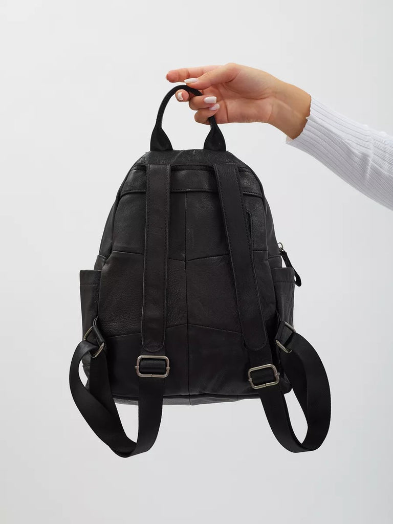 Black leather backpack for women, compact size, zippered pockets, adjustable straps, urban design, Mana model